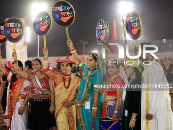 Participants perform 'Garba' during the Dainik Bhaskar Abhivyakti 'Garba Mahotsav' on the occasion of the Navratri festival in Jaipur, Rajas...