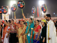 Participants perform 'Garba' during the Dainik Bhaskar Abhivyakti 'Garba Mahotsav' on the occasion of the Navratri festival in Jaipur, Rajas...