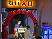 People watch a movie at China Film Digital International Cinema in the Fushan district of Yantai city, East China's Shandong province, on Oc...