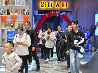 People watch a movie at China Film Digital International Cinema in the Fushan district of Yantai city, East China's Shandong province, on Oc...