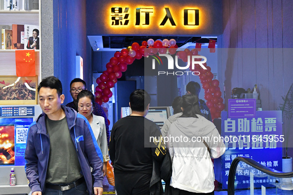 People watch a movie at China Film Digital International Cinema in the Fushan district of Yantai city, East China's Shandong province, on Oc...