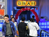 People watch a movie at China Film Digital International Cinema in the Fushan district of Yantai city, East China's Shandong province, on Oc...