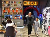 People watch a movie at China Film Digital International Cinema in the Fushan district of Yantai city, East China's Shandong province, on Oc...