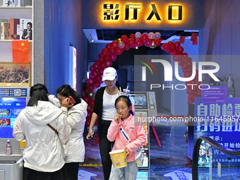 People watch a movie at China Film Digital International Cinema in the Fushan district of Yantai city, East China's Shandong province, on Oc...