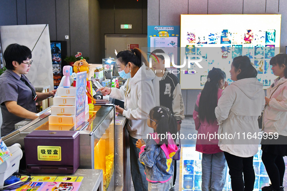 People buy tickets at the China Film Digital International Cinema in the Fushan district of Yantai, China, on October 7, 2024. 