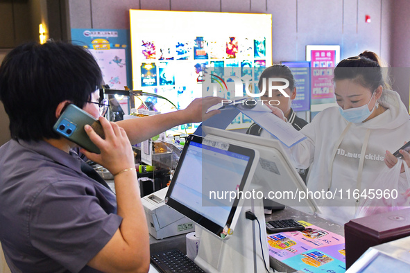 People buy tickets at the China Film Digital International Cinema in the Fushan district of Yantai, China, on October 7, 2024. 