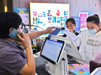 People buy tickets at the China Film Digital International Cinema in the Fushan district of Yantai, China, on October 7, 2024. (