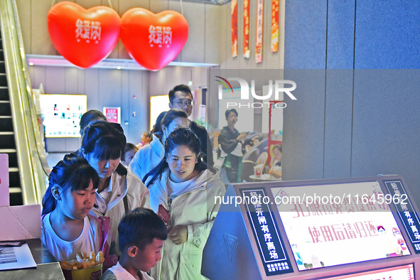 People buy snacks at the China Film Digital International Cinema in the Fushan district of Yantai, China, on October 7, 2024. 