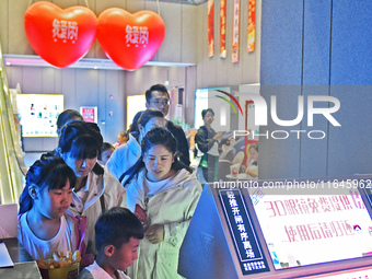 People buy snacks at the China Film Digital International Cinema in the Fushan district of Yantai, China, on October 7, 2024. (