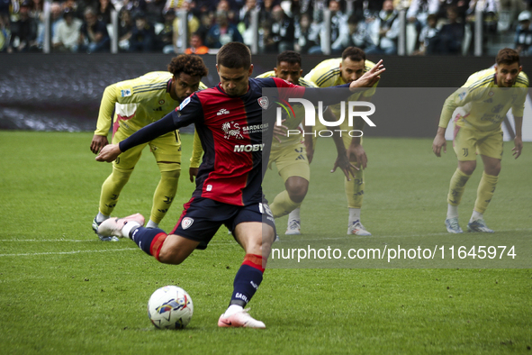 Cagliari midfielder Razvan Marin (18) scores his goal to make it 1-1 by penalty kick during the Serie A football match number 7, Juventus vs...