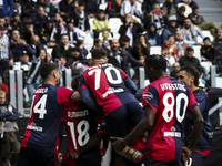 Cagliari midfielder Razvan Marin (18) celebrates with his teammates after scoring his goal to make it 1-1 during the Serie A football match...