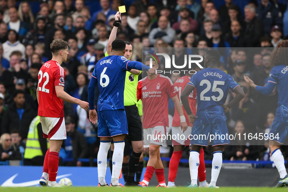 Referee Chris Kavanagh shows a yellow card to Levi Colwill of Chelsea during the Premier League match between Chelsea and Nottingham Forest...