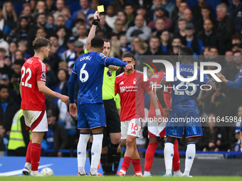 Referee Chris Kavanagh shows a yellow card to Levi Colwill of Chelsea during the Premier League match between Chelsea and Nottingham Forest...