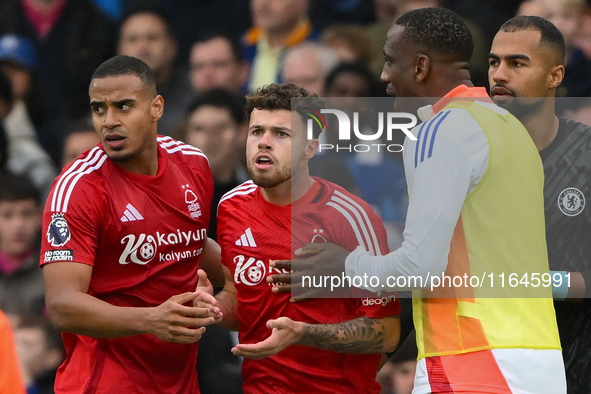 Neco Williams of Nottingham Forest is restrained by Murillo and Willy Boly, both of Nottingham Forest, during the Premier League match betwe...