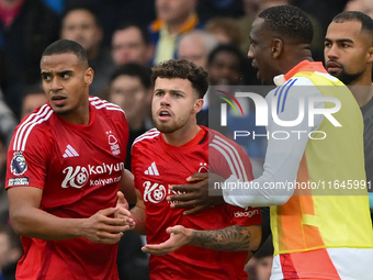 Neco Williams of Nottingham Forest is restrained by Murillo and Willy Boly, both of Nottingham Forest, during the Premier League match betwe...