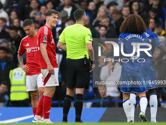 Ryan Yates of Nottingham Forest talks with referee Chris Kavanagh during the Premier League match between Chelsea and Nottingham Forest at S...