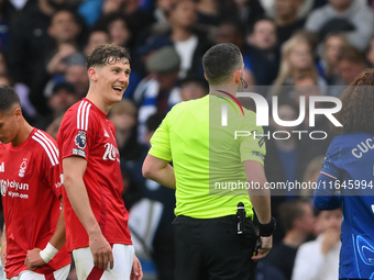 Ryan Yates of Nottingham Forest talks with referee Chris Kavanagh during the Premier League match between Chelsea and Nottingham Forest at S...