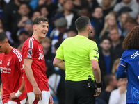 Ryan Yates of Nottingham Forest talks with referee Chris Kavanagh during the Premier League match between Chelsea and Nottingham Forest at S...