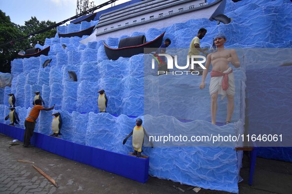 Workers make a pandal for the Durga Puja festival in Nagaon District, Assam, India, on October 7, 2024. 