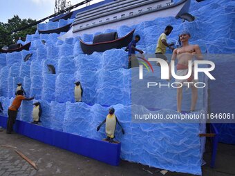 Workers make a pandal for the Durga Puja festival in Nagaon District, Assam, India, on October 7, 2024. (