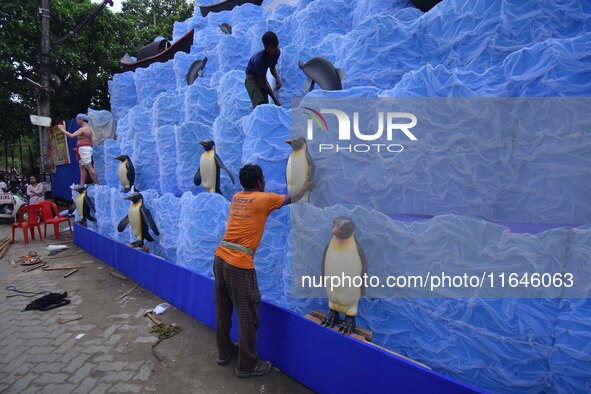 Workers make a pandal for the Durga Puja festival in Nagaon District, Assam, India, on October 7, 2024. 