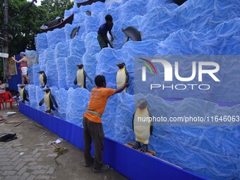 Workers make a pandal for the Durga Puja festival in Nagaon District, Assam, India, on October 7, 2024. (