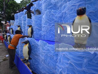 Workers make a pandal for the Durga Puja festival in Nagaon District, Assam, India, on October 7, 2024. (