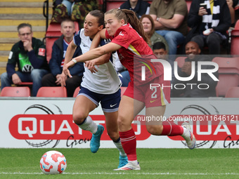 In London, England, on October 6, 2024, Lucy Parry of Liverpool Women (red) tussles with Hayley Raso of Tottenham Hotspur Women during the B...