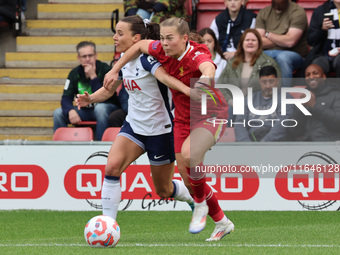 In London, England, on October 6, 2024, Lucy Parry of Liverpool Women (red) tussles with Hayley Raso of Tottenham Hotspur Women during the B...