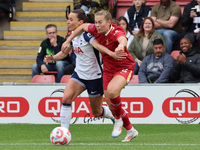 In London, England, on October 6, 2024, Lucy Parry of Liverpool Women (red) tussles with Hayley Raso of Tottenham Hotspur Women during the B...