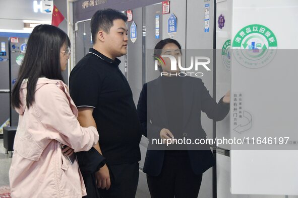 Consumers shop for refrigerators at a trade-in promotion for home appliances in Handan, China, on October 7, 2024. 