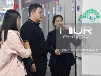 Consumers shop for refrigerators at a trade-in promotion for home appliances in Handan, China, on October 7, 2024. (