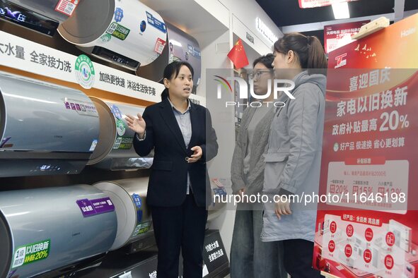 Consumers buy water heaters at an appliance trade-in promotion event in Handan, China, on October 7, 2024. 