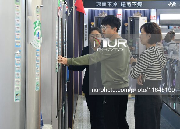 Consumers shop for air conditioners at a trade-in promotion for home appliances in Handan, China, on October 7, 2024. 