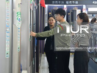 Consumers shop for air conditioners at a trade-in promotion for home appliances in Handan, China, on October 7, 2024. (