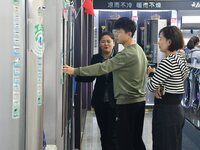 Consumers shop for air conditioners at a trade-in promotion for home appliances in Handan, China, on October 7, 2024. (