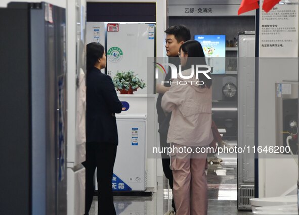 Consumers shop for home appliances at a trade-in promotion event in Handan, China, on October 7, 2024. 