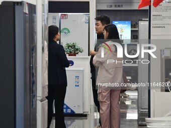 Consumers shop for home appliances at a trade-in promotion event in Handan, China, on October 7, 2024. (