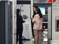 Consumers shop for home appliances at a trade-in promotion event in Handan, China, on October 7, 2024. (