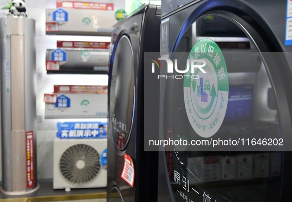 A trade-in logo of consumer goods is displayed at a home appliance trade-in promotion event in Yongnian district, Handan, China, on October...