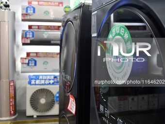 A trade-in logo of consumer goods is displayed at a home appliance trade-in promotion event in Yongnian district, Handan, China, on October...