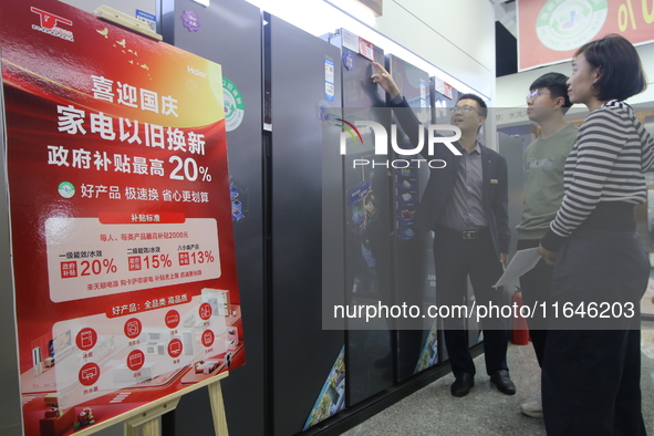 Consumers shop for refrigerators at a trade-in promotion for home appliances in Handan, China, on October 7, 2024. 