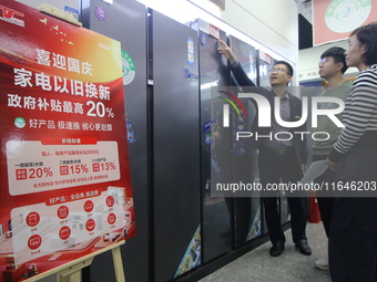 Consumers shop for refrigerators at a trade-in promotion for home appliances in Handan, China, on October 7, 2024. (