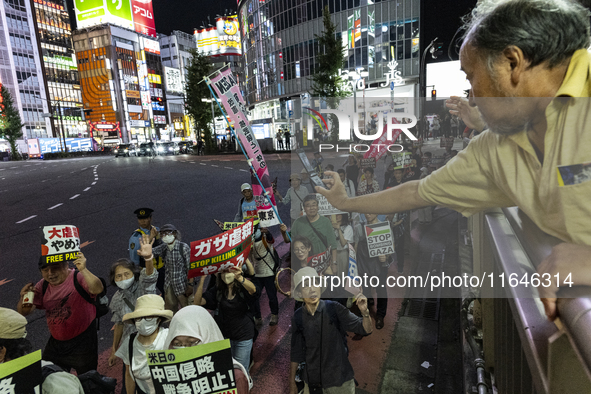 Pro-Palestinian people march through downtown in Tokyo, Japan, on October 7, during the protest against Israeli military actions in Gaza, 20...