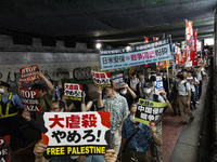 Demonstrators hold placards and show solidarity with Palestinians during the protest against Israeli military actions in Gaza on October 7,...