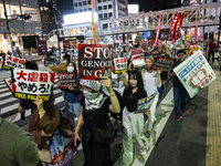 Demonstrators hold placards and show solidarity with Palestinians during the protest against Israeli military actions in Gaza on October 7,...