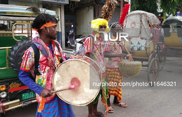 Tribal community people who work in the tea garden collect donations for the upcoming 'Dashai Puja,' which is celebrated during the Dusshera...