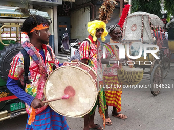 Tribal community people who work in the tea garden collect donations for the upcoming 'Dashai Puja,' which is celebrated during the Dusshera...