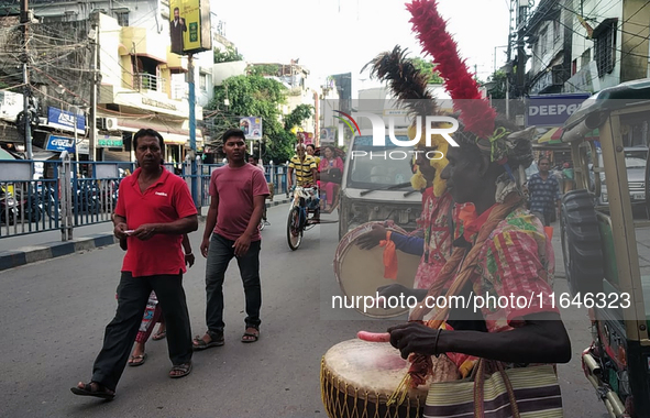 Tribal community people who work in the tea garden collect donations for the upcoming 'Dashai Puja,' which is celebrated during the Dusshera...