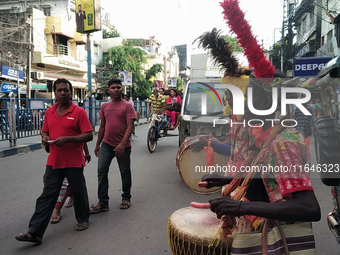 Tribal community people who work in the tea garden collect donations for the upcoming 'Dashai Puja,' which is celebrated during the Dusshera...